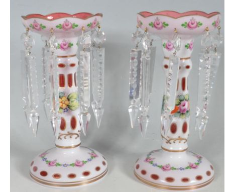 A pair of 20th century antique Victorian style cranberry glass lustres. The lustres of a cylindrical form having a scalloped 