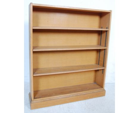 A good 1920's light oak open window bookcase cabinet. The shelves being raised on a plinth base with open front having adjust