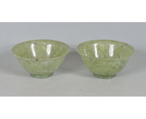 A pair of two 20th century Chinese oriental jade bowl / rice bows of traditional cylindrical corm with lipped rim raised on a