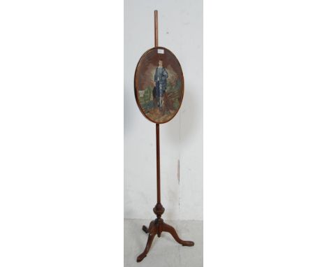 A 19th century Regency mahogany and tapestry pole screen. Raised on a splayed leg tripod base with upright mahogany pole to c