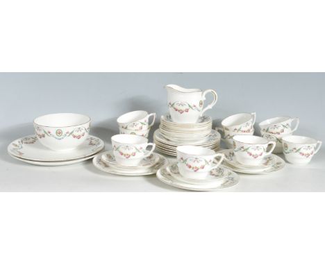 A vintage Collingwoods ceramic tea service having a white ground with rose garland decoration and gilt rims. includes tea cup