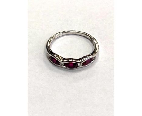 An 18ct white gold ruby and diamond band ring
