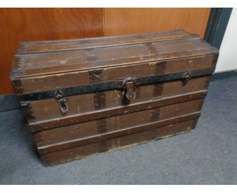 An antique oak bound domed shipping trunk 