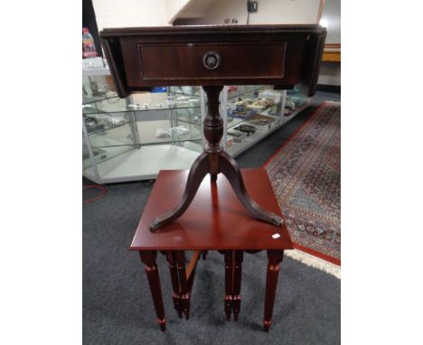 A nest of three tables in a mahogany finish together with a pedestal sofa table with inset leather panel 