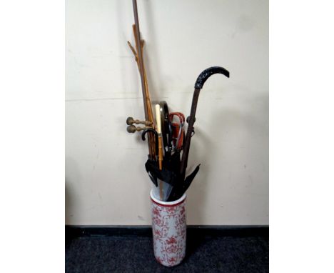 A ceramic stick pot containing selection of walking sticks, crooks, 19th century curtain rail, parasols etc 