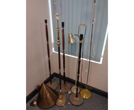 A 20th century brass conical light fitting together with six continental floor lamps 