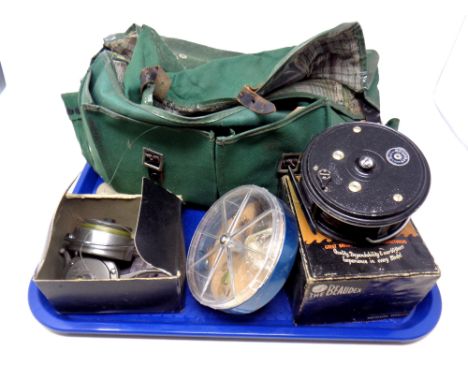 A canvas fishing bag containing a Beaudex reel, boxed, fishing hooks, Movado reel with line