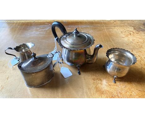 An Edwardian three piece silver miniature tea set, Birmingham 1901, by Walker and Hall, comprising teapot, milk jug, sugar bo