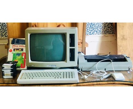 A 1985 Amstrad PCW word processor (256K) complete with a printer, books and floppy disk games.Amstrad was a British electroni