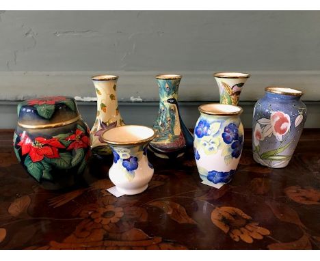 Seven assorted miniature Moorcroft enamel vases, various patterns (7)