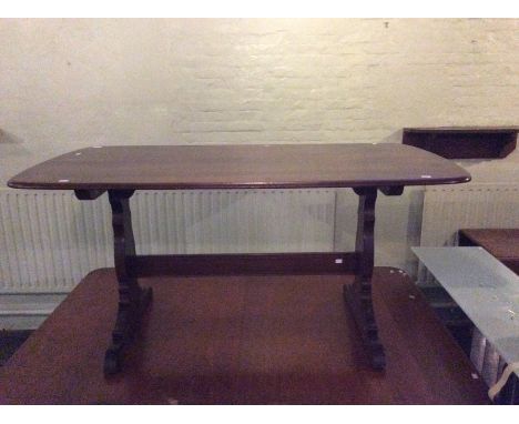 An Ercol elm topped dining table, the top with a trestle type frame, 72cm high, 148cm wide, 85cm deep