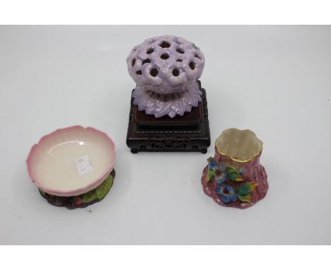 A group of Royal Worcester including a pomander modelled as a posy of purple flowers, green mark,&nbsp;on Chinoiserie wooden 