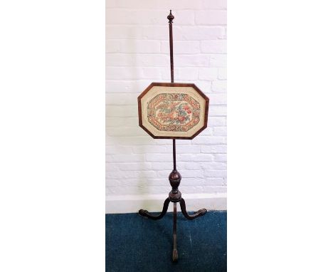 A Victorian revival textile art pole-screen, globe finial on a round pole holding an octagonal frame glazed inlay with floral