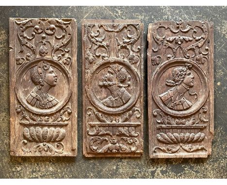 Three English school Elizabethan oak wall panels, circa 1560, portrait carving of Romanesque maids and a gentleman with scrol