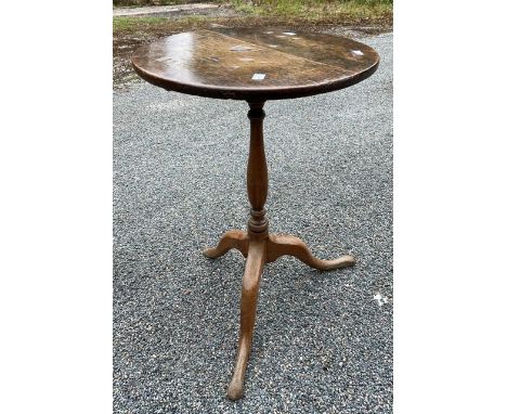 A George III oak wine table, circa 1800, circular top on a turned column, raised on a tripod platform with three cabriole leg