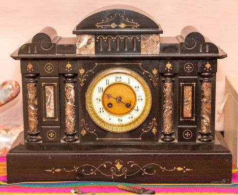 A French late 19th Century ebonised marble architectural mantel clock, arch scrolling top above a circular white enamel chapt