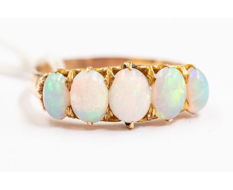 An opal and 14ct gold ring, set with five graduated oval opals, claw set,  size V, unmarked, total gross weight approx. 5gms 