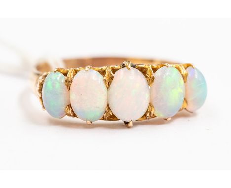 An opal and 14ct gold ring, set with five graduated oval opals, claw set,  size V, unmarked, total gross weight approx. 5gms 