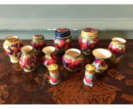 Eleven assorted Moorcroft enamel pomegranate pattern miniature vessels (11)