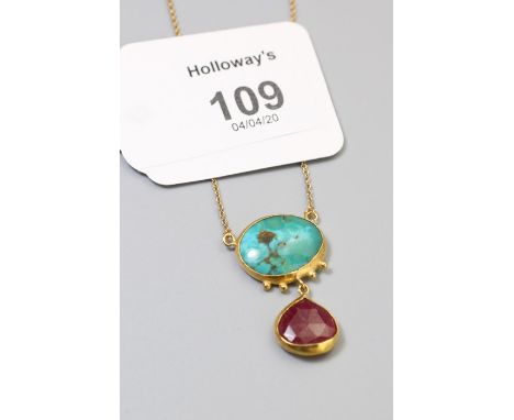 A ruby and turquoise pendant, the heart-shaped ruby and oval turquoise to a trace link chain, 40cm Gross weight 5.5g