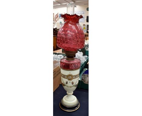 A late 19th Century ruby glass and enamelled oil lamp along with three Victorian hand painted vases and spare shade