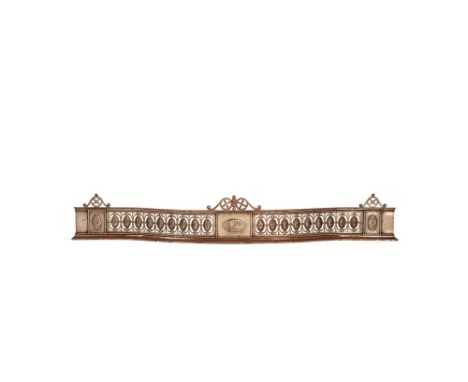 A late George III or Regency steel fender, early 19th century, the openwork and serpentine gallery with floral paterae and be
