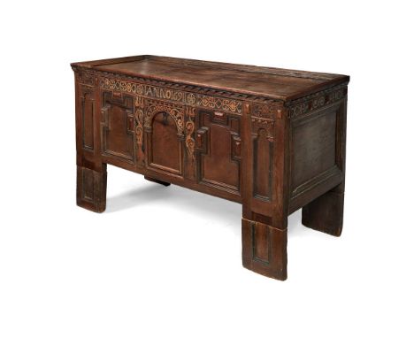 A 17th century style carved oak coffer, the moulded single panel top above a panelled front incorporating headed by 'Anno 169