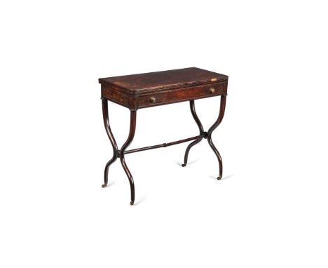 ϒA Regency rosewood small card table, circa 1815 in the Empire style, with a rounded rectangular swivelling top revealing an 