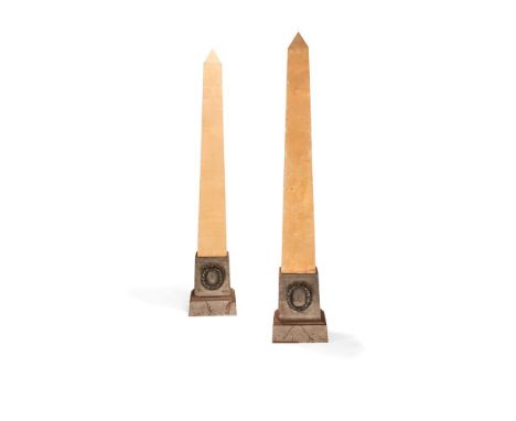 A pair of plywood and cast iron obelisk standard lamps, the plinths probably early 20th century, the shafts modern, the taper