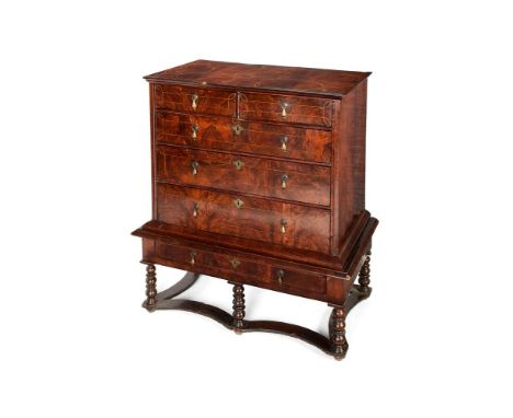 A Queen Anne and later, figured walnut chest on stand, the top inlaid with interlocking roundels of stringing, the two short 