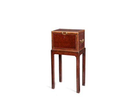 A George II burr yew, padouk and inlaid strong box on stand, mid-18th century, the brass-mounted box inlaid with chevron band