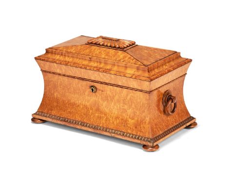 A George IV or William IV birds eye maple veneered tea caddy, circa 1830, of sarcophagus form, the domed and hinged cover wit