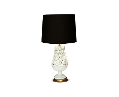 A modern Spanish cream coloured pottery lamp base modelled as a bowl of pomegranates, on gilt wood base and fitted for electr
