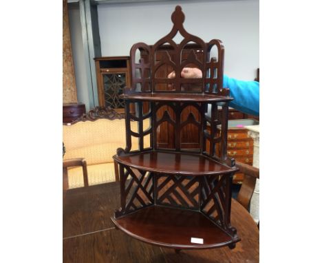 A Chippendale design corner wall shelf of three tiers and trellis design.