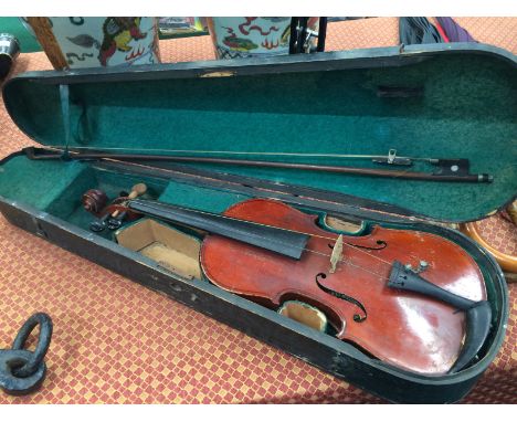 A German violin in fitted case together with an ebony and Mother of Pearl inlaid bow.