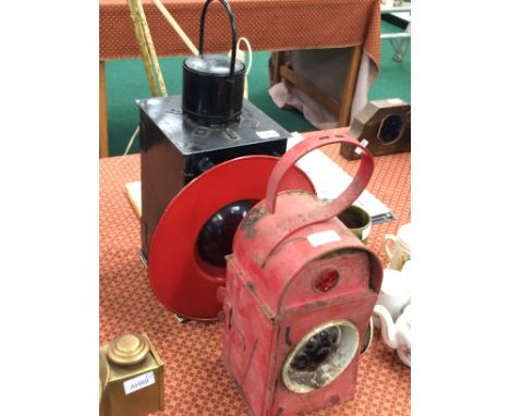 A red Kenyons Patent Serilight lens lamp and one other.