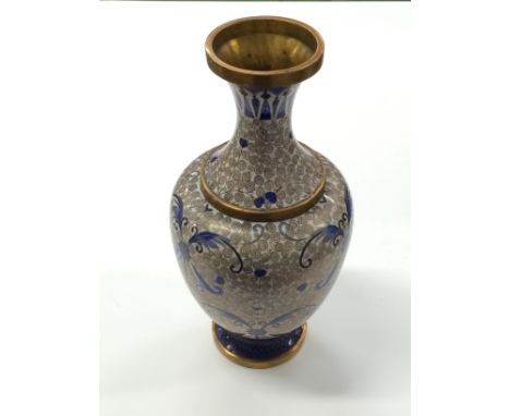 A Chinese Cloisonne vase decorated in blue enamel on a pink back ground.