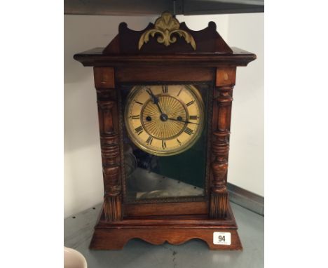 An oak cased repeater mantle clock, circular dial with Roman numerals.