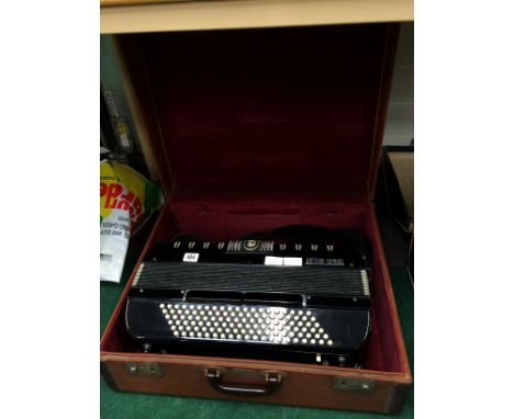 A Settimio Soprani Italian concertina in black with ivory buttons in case. 