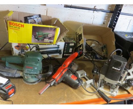 Boxed power tools to include a Bosch sander, a Trend router with accessories and a Black &amp; Decker sander etc