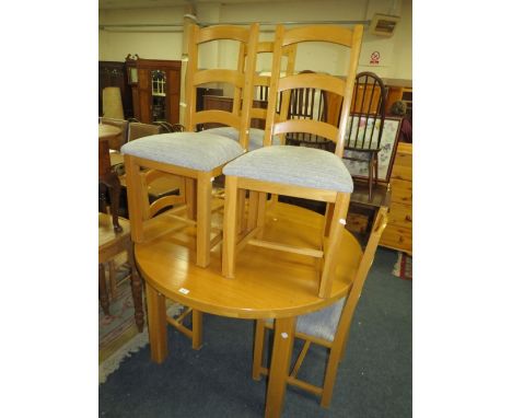 A modern light oak extending dining table and six chairs
