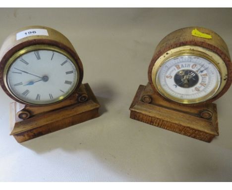 A small wooden mantle clock a with a matching barometer