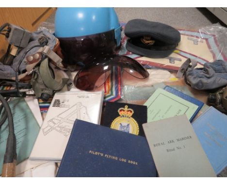 A tray of military and aviation collectables to include pilot helmet, fly log book circa 1990 etc