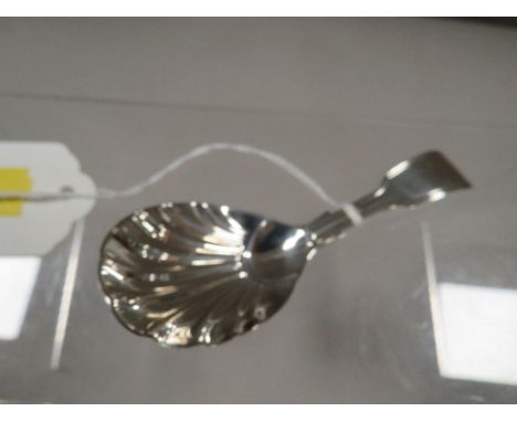 A hallmarked early Victorian silver caddy spoon with scalloped bowl
