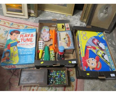 Two trays of vintage toys to include tug boat, marbles, Chad Valley Play a Tune, Scalextric etc