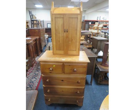 A honey pine five drawer chest together with a two door light oak cabinet. (2)