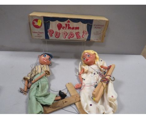 A vintage boxed Pelham puppet together with another