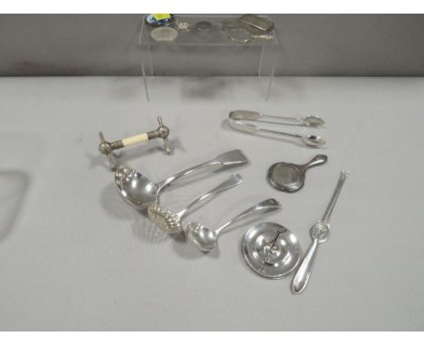 A small tray of collectable silver and plated ware to include a small hallmarked silver ladle, hallmarked silver ring tree, m