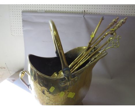 A brass helmet coal scuttle with companion items
