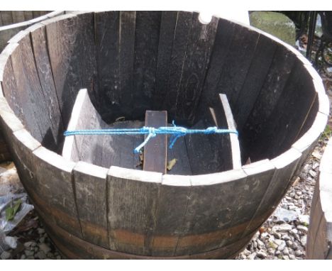 A very large half barrel oak garden planter